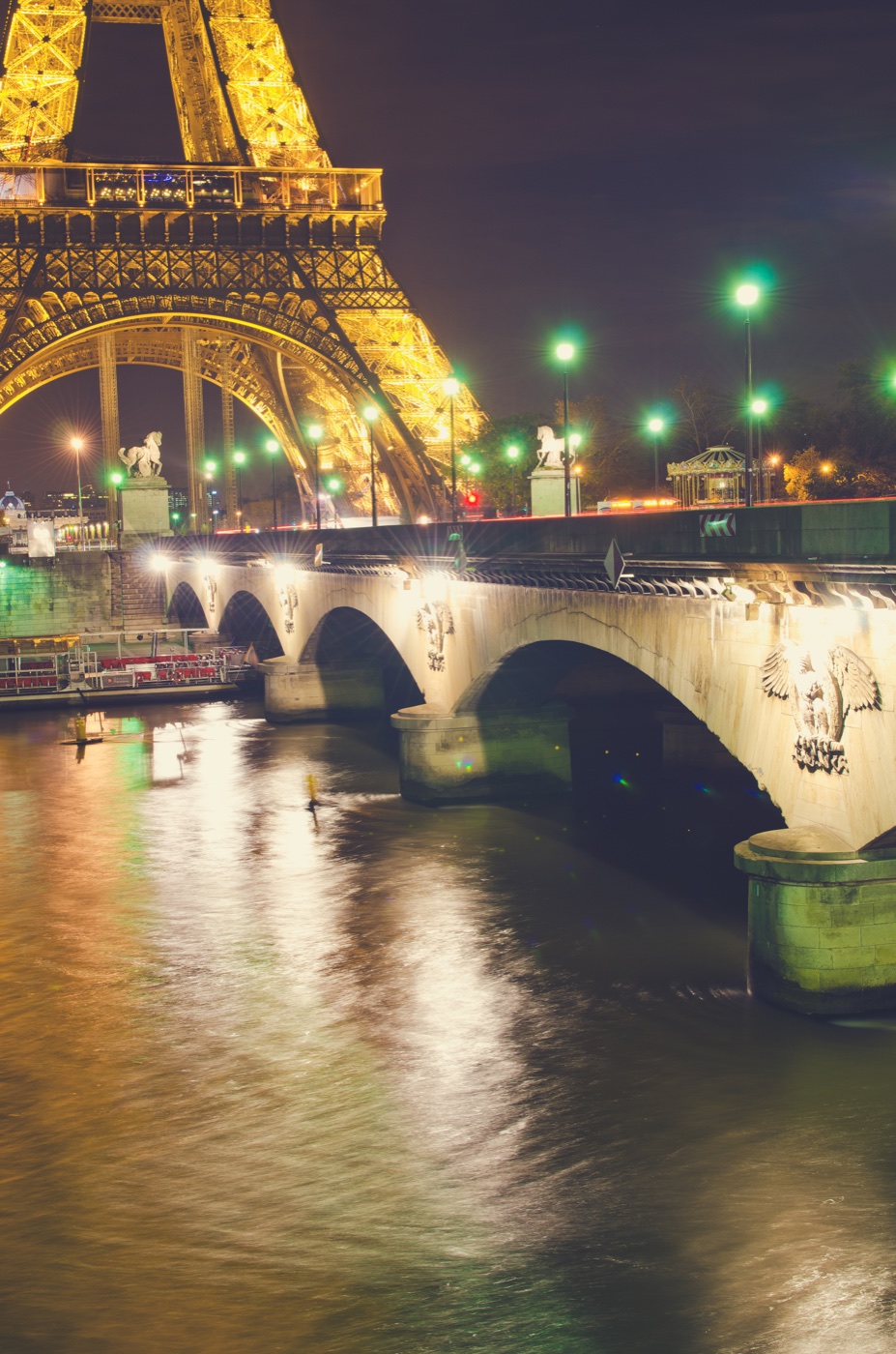 Paris bridge illuminated at night